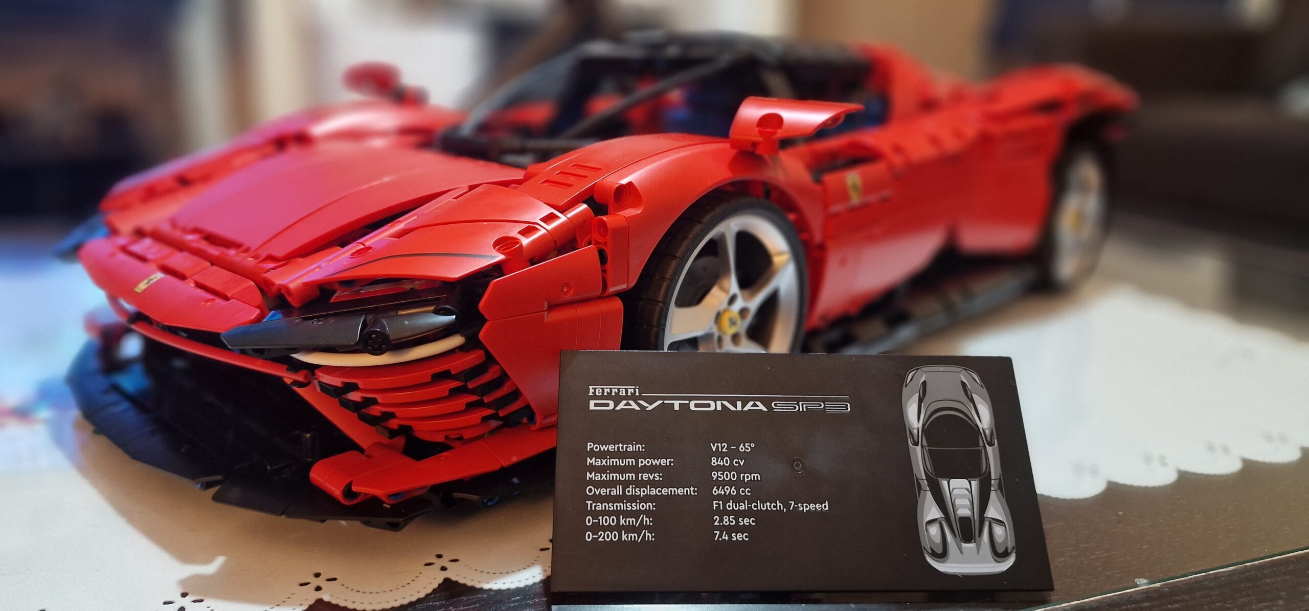 LEGO Technic Ferrari Daytona SP3 42143 front 3/4 with Daytona spec card