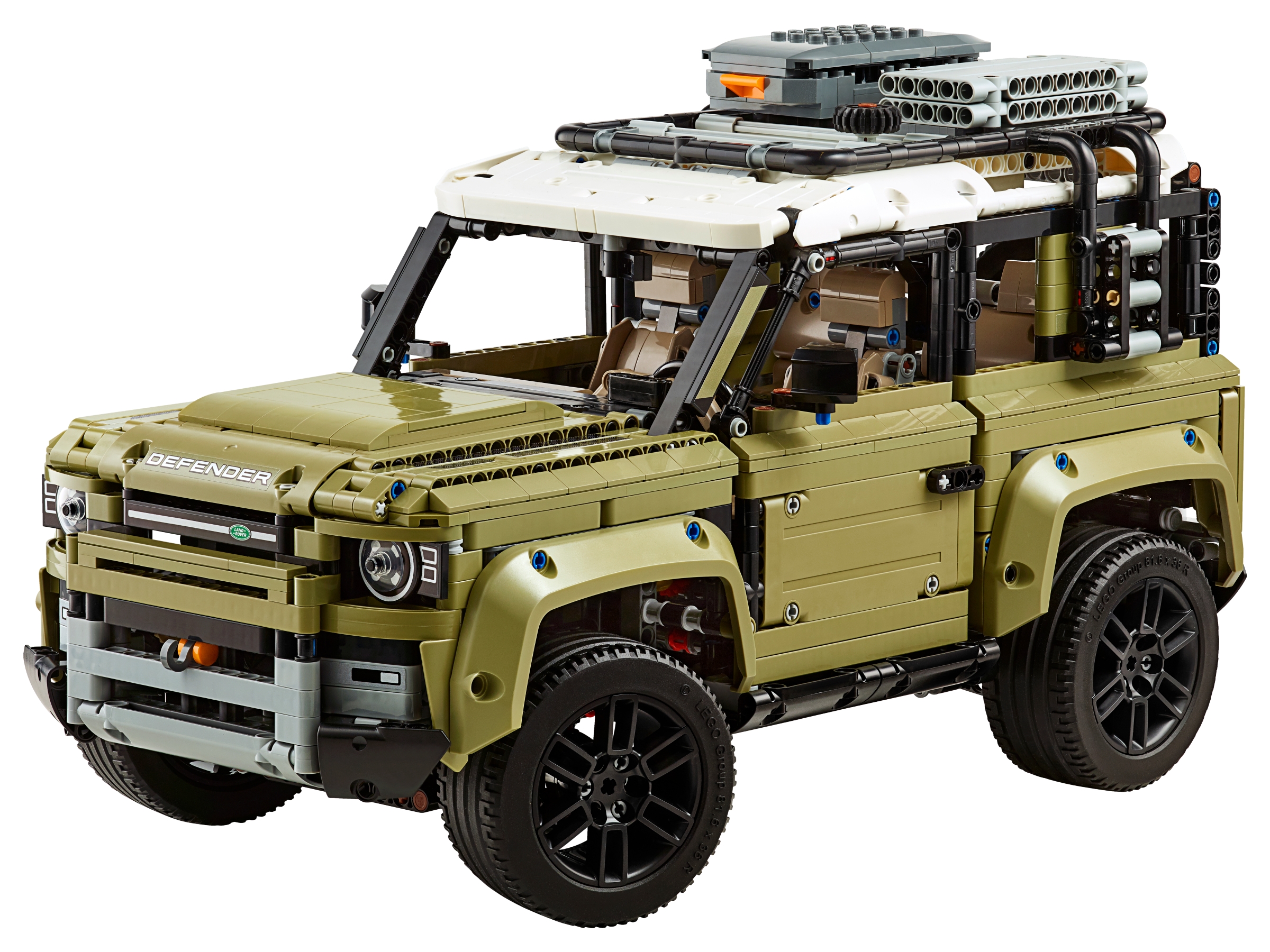 LEGO Technic Land Rover Defender (42110) from the front three-quarter: DEFENDER lettering on the bonnet, stickered headlights, the orange winch hook in the bumper and the olive green mudguards over black six-spoke wheels