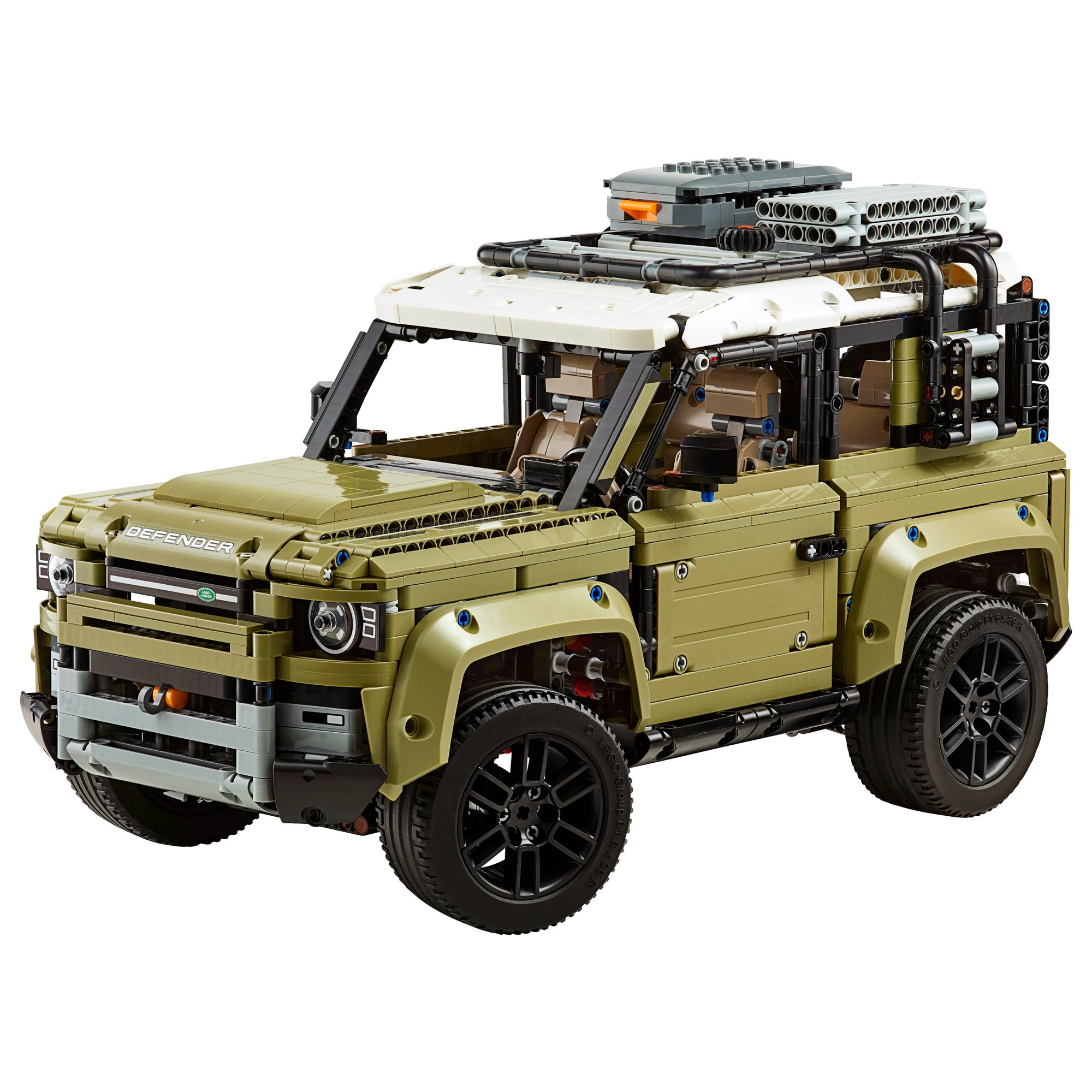 LEGO Technic Land Rover Defender (42110) from the front three-quarter, showing the roof rack with the grey storage box and two bundles of bridging plates over the white roof