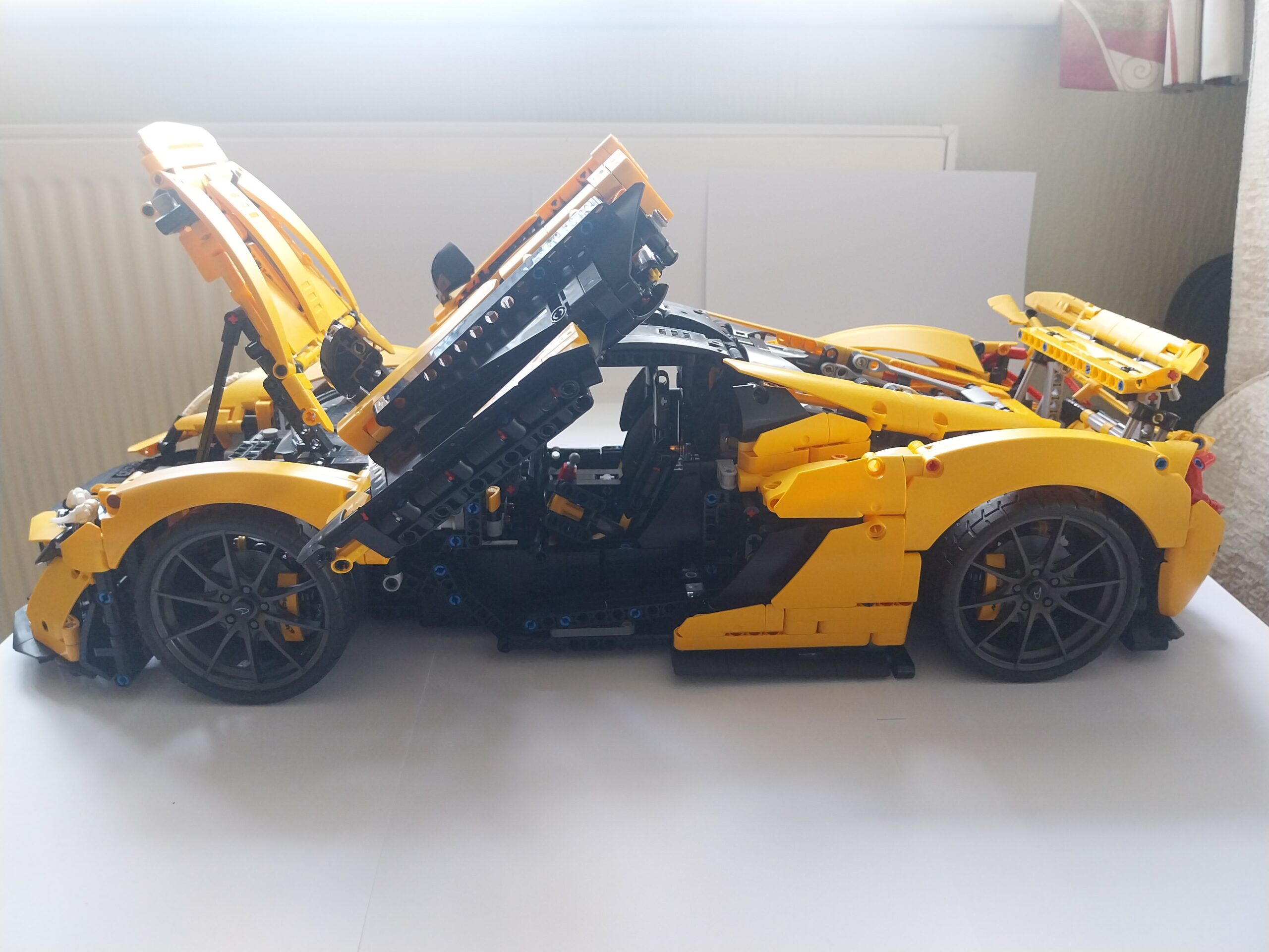 LEGO Technic McLaren P1 42172 member build diary, completed yellow car side view with butterfly doors open, front hood up showing engine, rear wing fully deployed