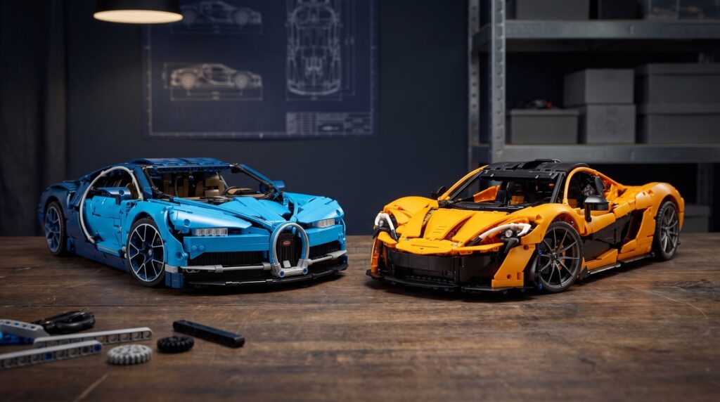 LEGO Technic Bugatti Chiron (42083) and McLaren P1 (42172) side by side on a workbench