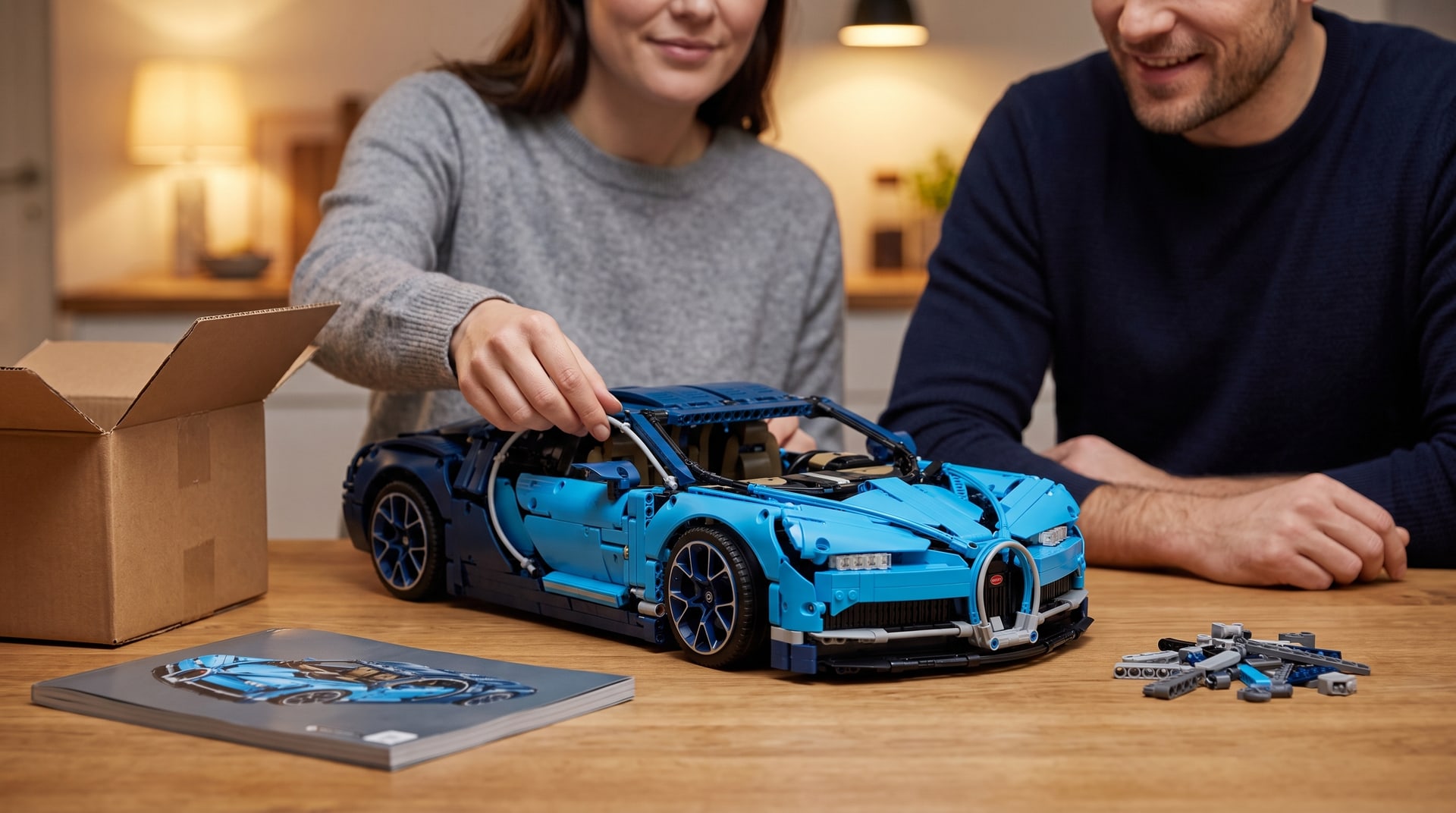 Two adults at the kitchen table with a built LEGO Technic Bugatti Chiron (42083)