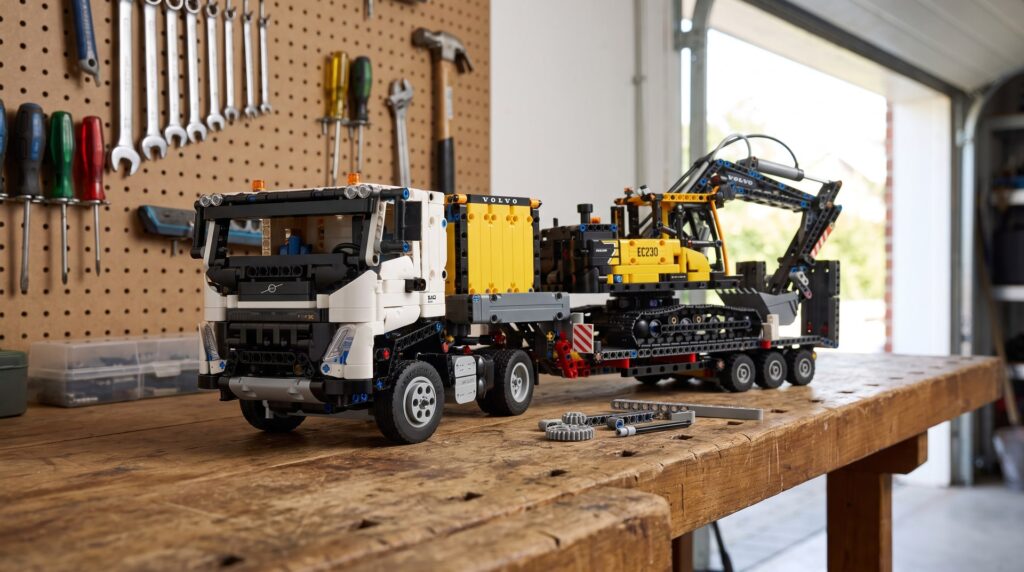 LEGO Technic Volvo FMX Truck and EC230 Electric Excavator (42175) on a workbench in a home garage
