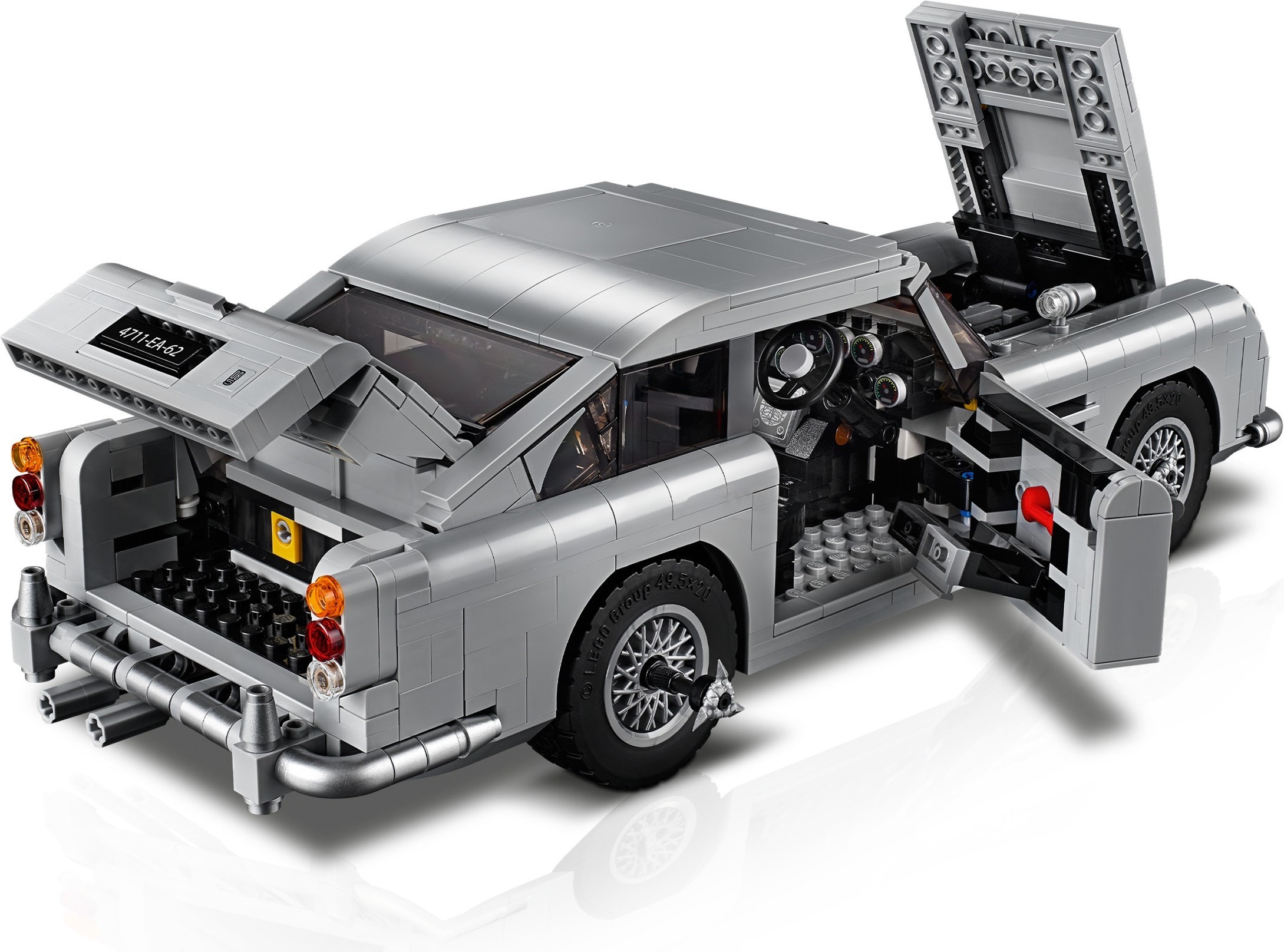 Rear three-quarter view of LEGO James Bond Aston Martin DB5 (10262) with the boot, bonnet and driver's door open, the red telephone in the door and a tyre scythe fitted to the rear wheel