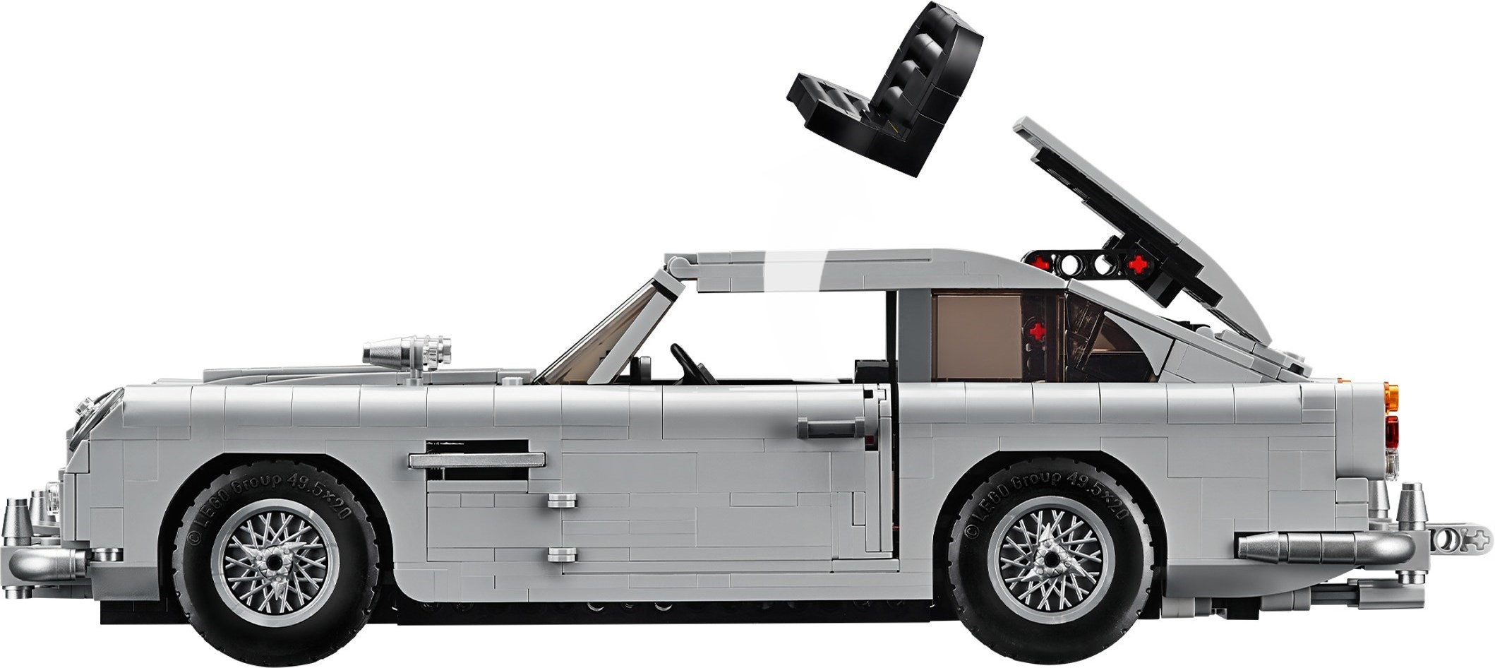 Side profile of LEGO James Bond Aston Martin DB5 (10262) with the roof hatch open and the black passenger seat in the air above the car