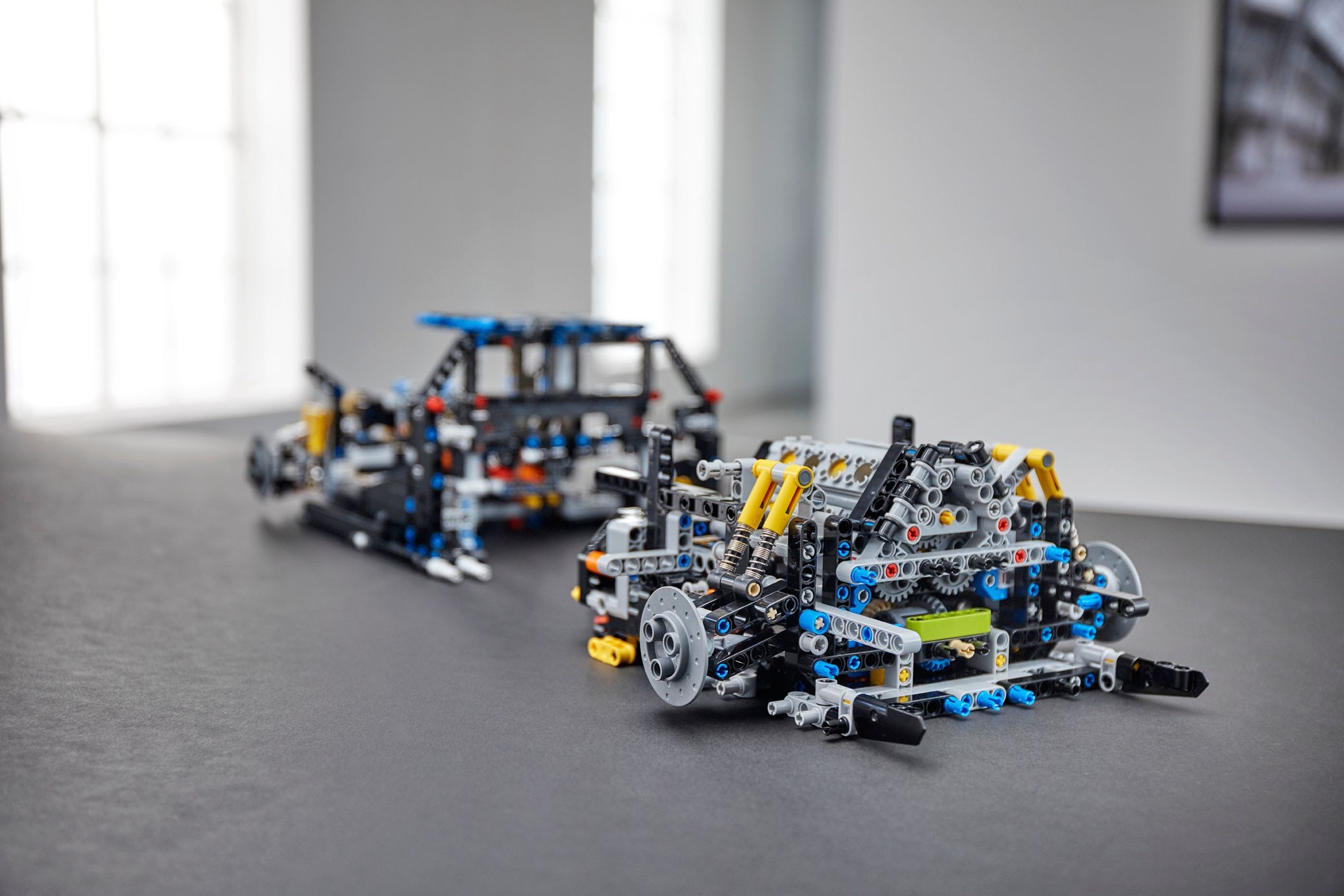 The two chassis halves of LEGO Technic Bugatti Chiron (42083) before they are joined: rear gearbox and engine unit in front, front monocoque behind