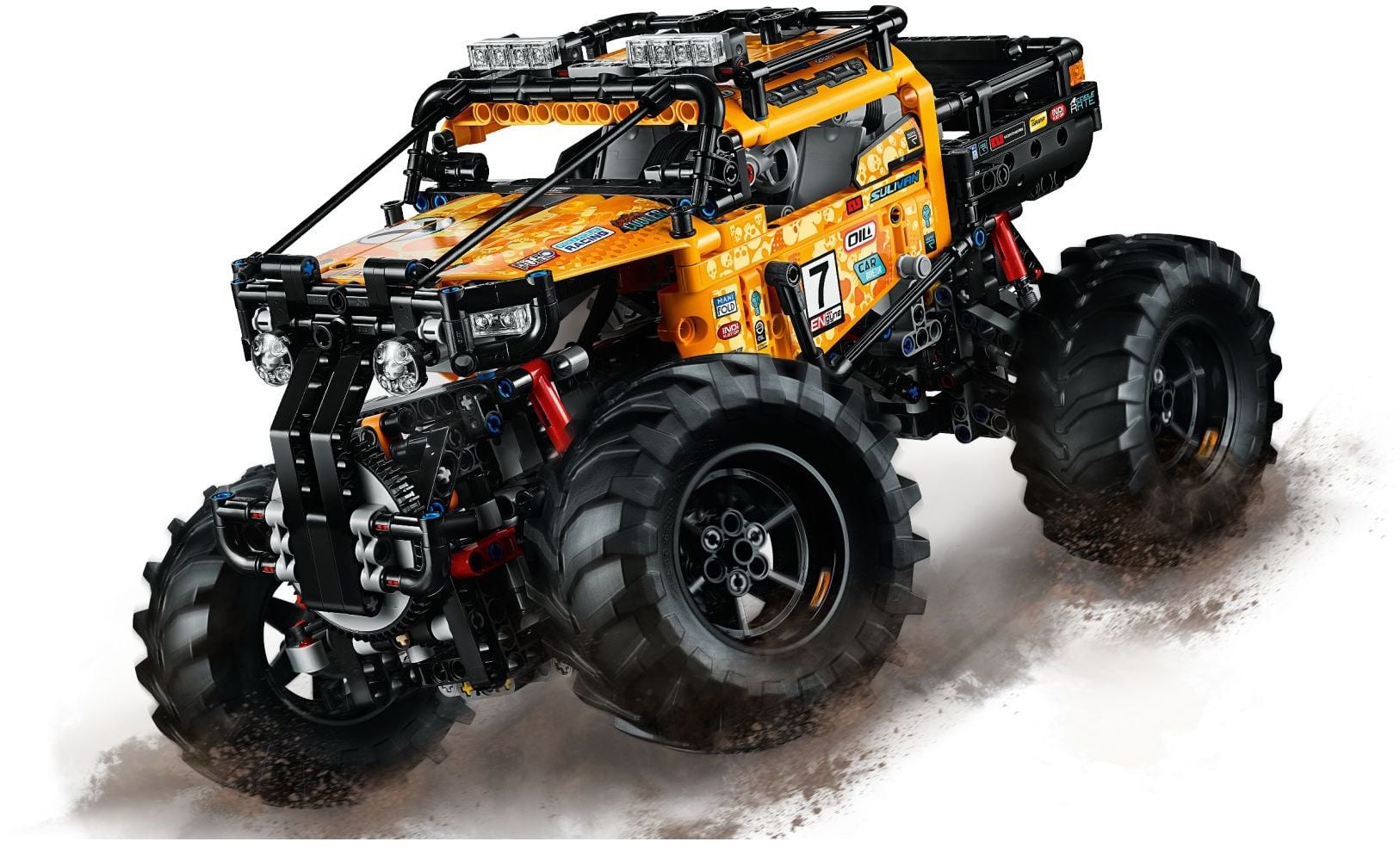 Front three-quarter view of LEGO Technic 4x4 X-treme Off-Roader (42099) kicking up dust, showing the black bumper guard, headlight pods and red shock absorbers