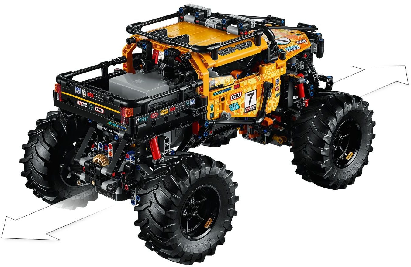Rear three-quarter view of LEGO Technic 4x4 X-treme Off-Roader (42099) showing the grey Smart Hub in the open rear bed and arrows marking drive in both directions
