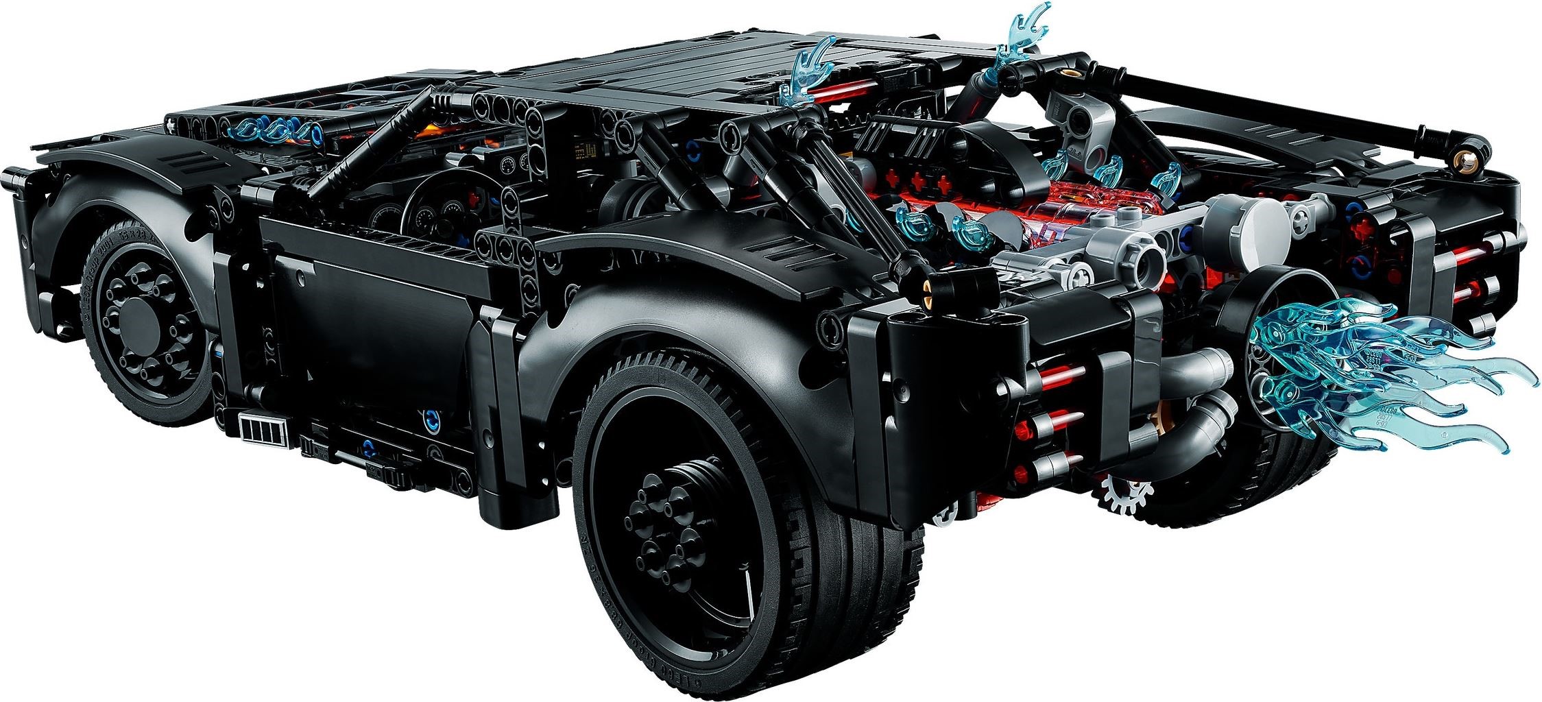 Rear three-quarter view of LEGO Technic THE BATMAN Batmobile (42127) showing the V8 with red glow, exhaust manifolds, the light blue jet flame on the exhaust hub, red tail light bars and the roof struts