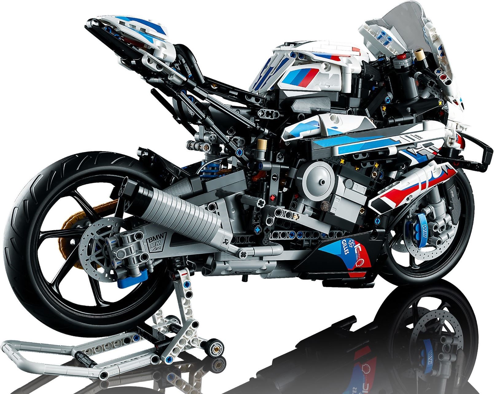 Right-hand side of LEGO Technic BMW M 1000 RR (42130) seen from slightly behind, on the racing stand, showing the bare black tail subframe, the ribbed silver exhaust can, the swingarm and the rear brake disc