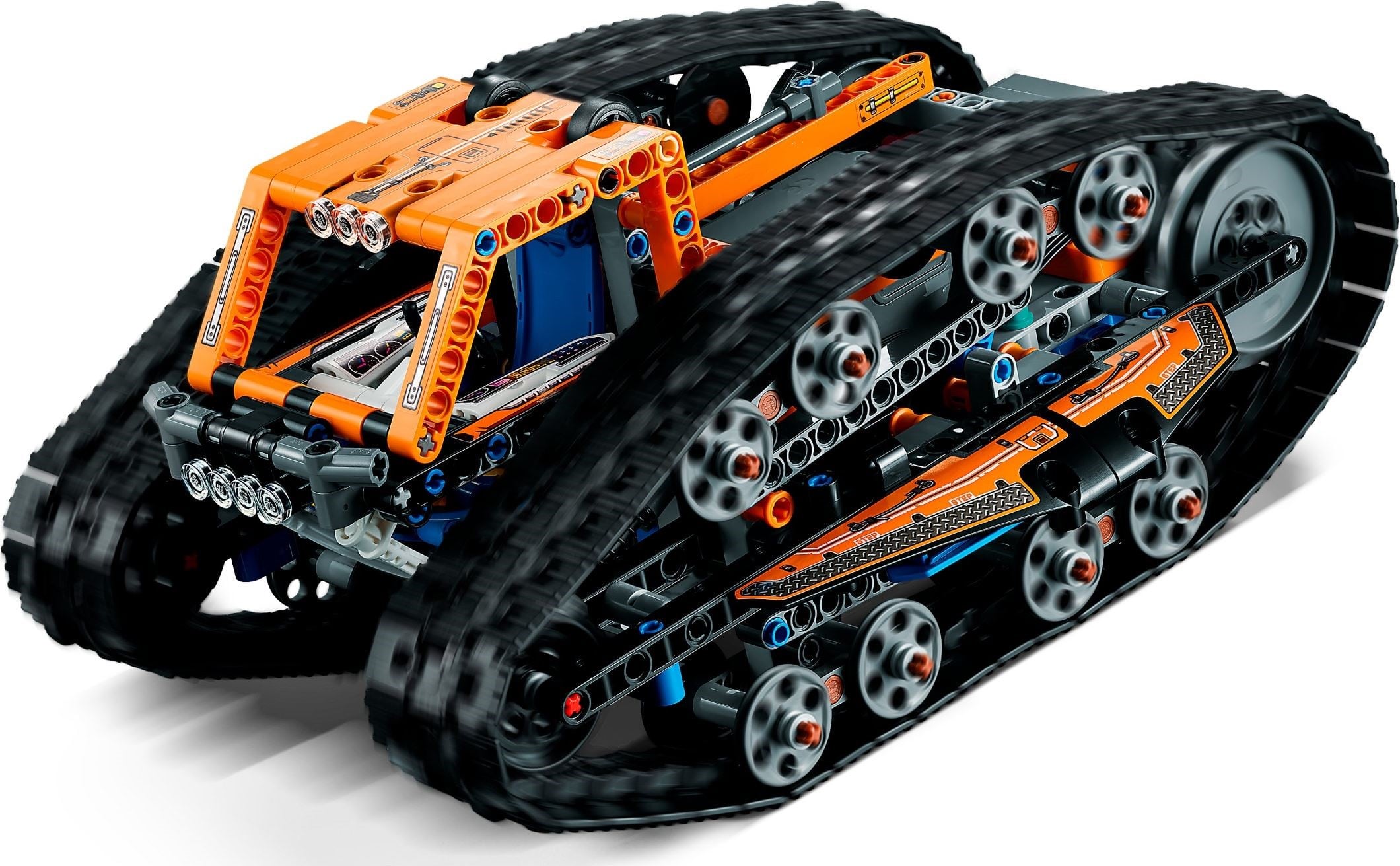 LEGO Technic App-Controlled Transformation Vehicle (42140) with the orange truck side up, showing the open cab with a white dashboard, two small black wheels on the cab roof, the light bar, the orange flatbed frame behind and the eight guide-wheel bogies inside the track