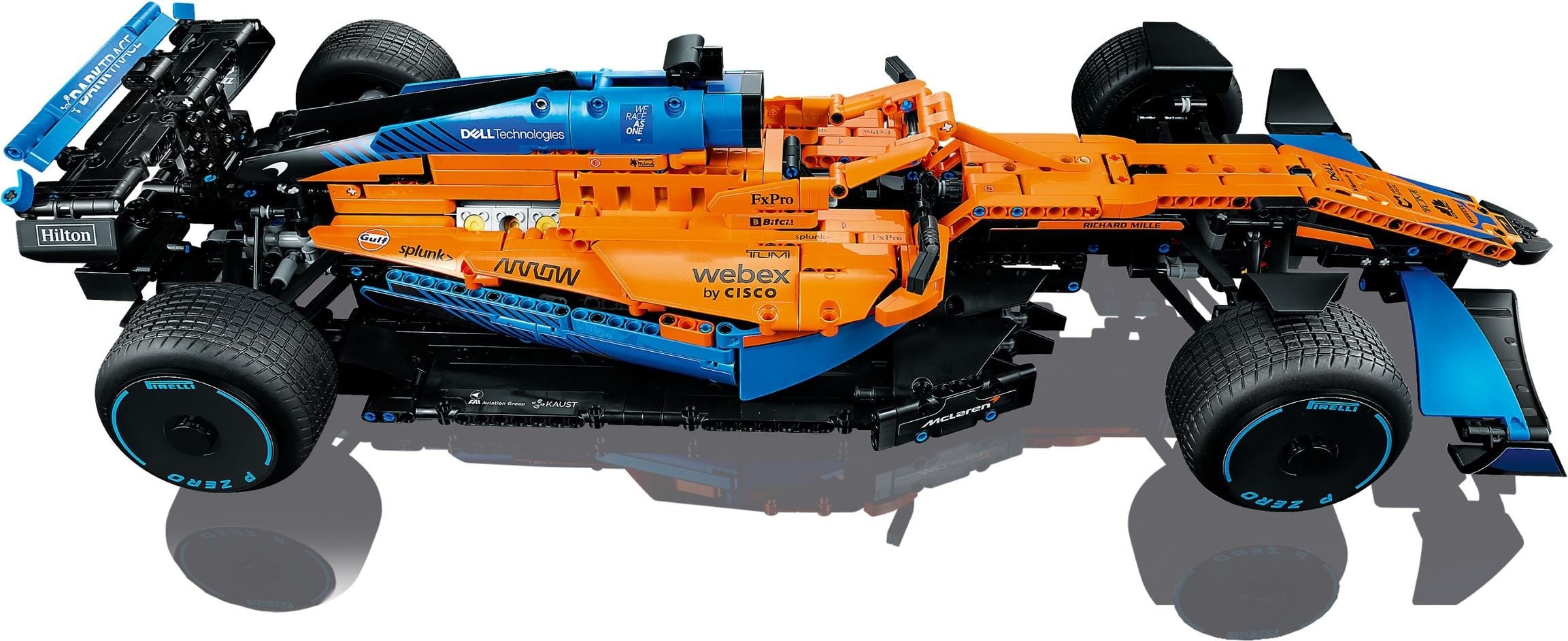 LEGO Technic McLaren Formula 1 Race Car (42141) seen from above and slightly to the side, showing the layered orange sidepod panels, the halo over the cockpit, the blue airbox and the opening behind the cockpit where the engine cylinders show