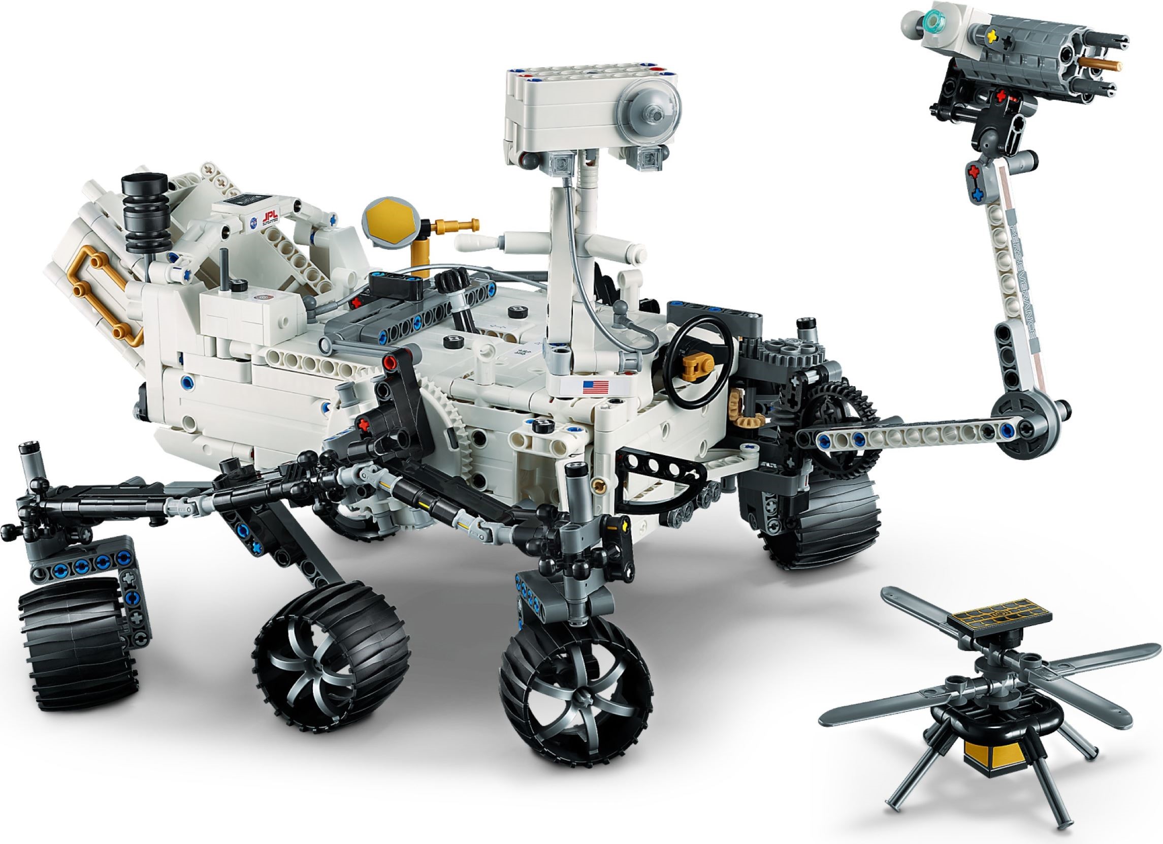 Front three-quarter view of LEGO Technic NASA Mars Rover Perseverance (42158) with the robotic arm raised, the black steering wheel and orange lever on top of the body, dark grey gears at the side and the Ingenuity helicopter standing on the ground beside it